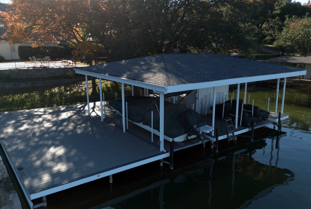 An elegant, custom-built lakeside dock with a spacious covered area and an extended sun deck on Lake Granbury. The offset design maximizes entertainment space while maintaining an open view of the water.