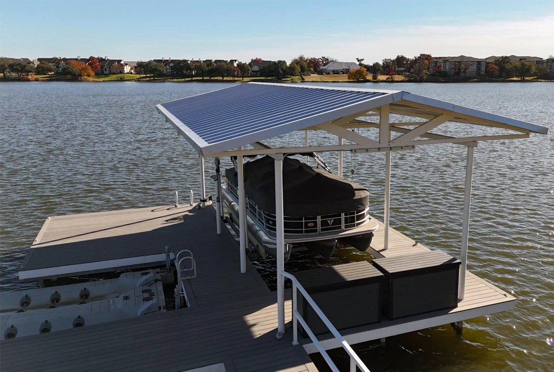 A beautifully designed stationary dock on Lake Granbury, featuring a sleek metal roof and boat lift, strategically placed to comply with HOA regulations while maintaining the homeowner’s lake view.